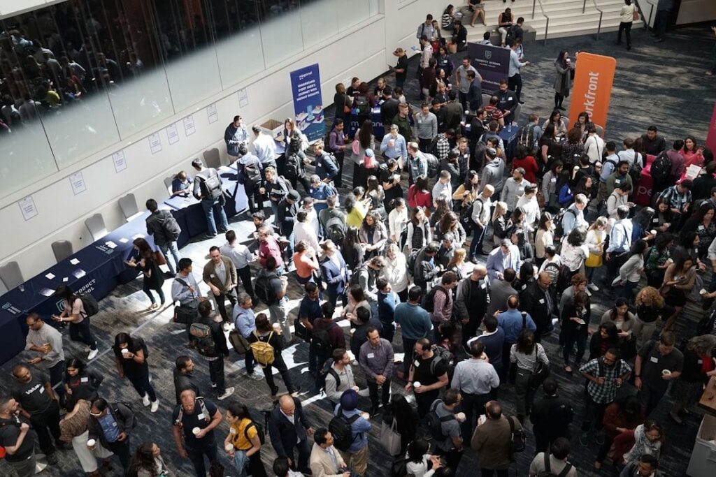High-angle view of a crowded trade show floor with many attendees.
