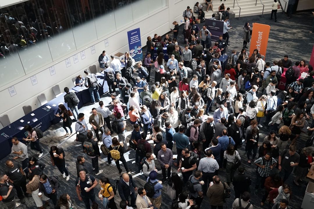 High-angle view of a crowded trade show floor with many attendees.