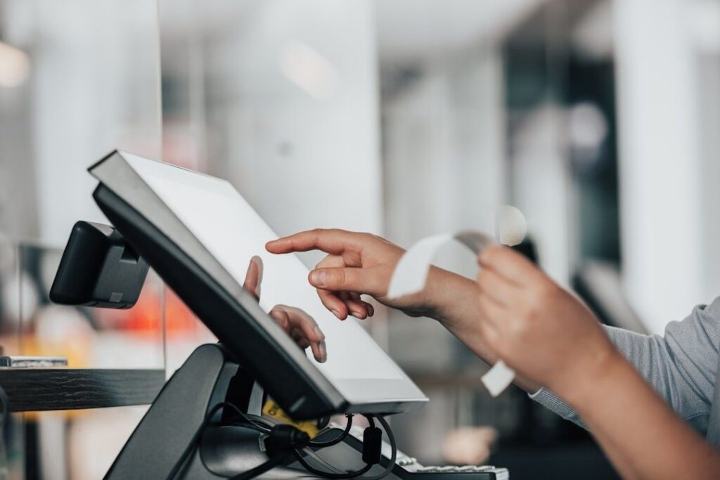 Customer using a payment terminal while holding a contactless card